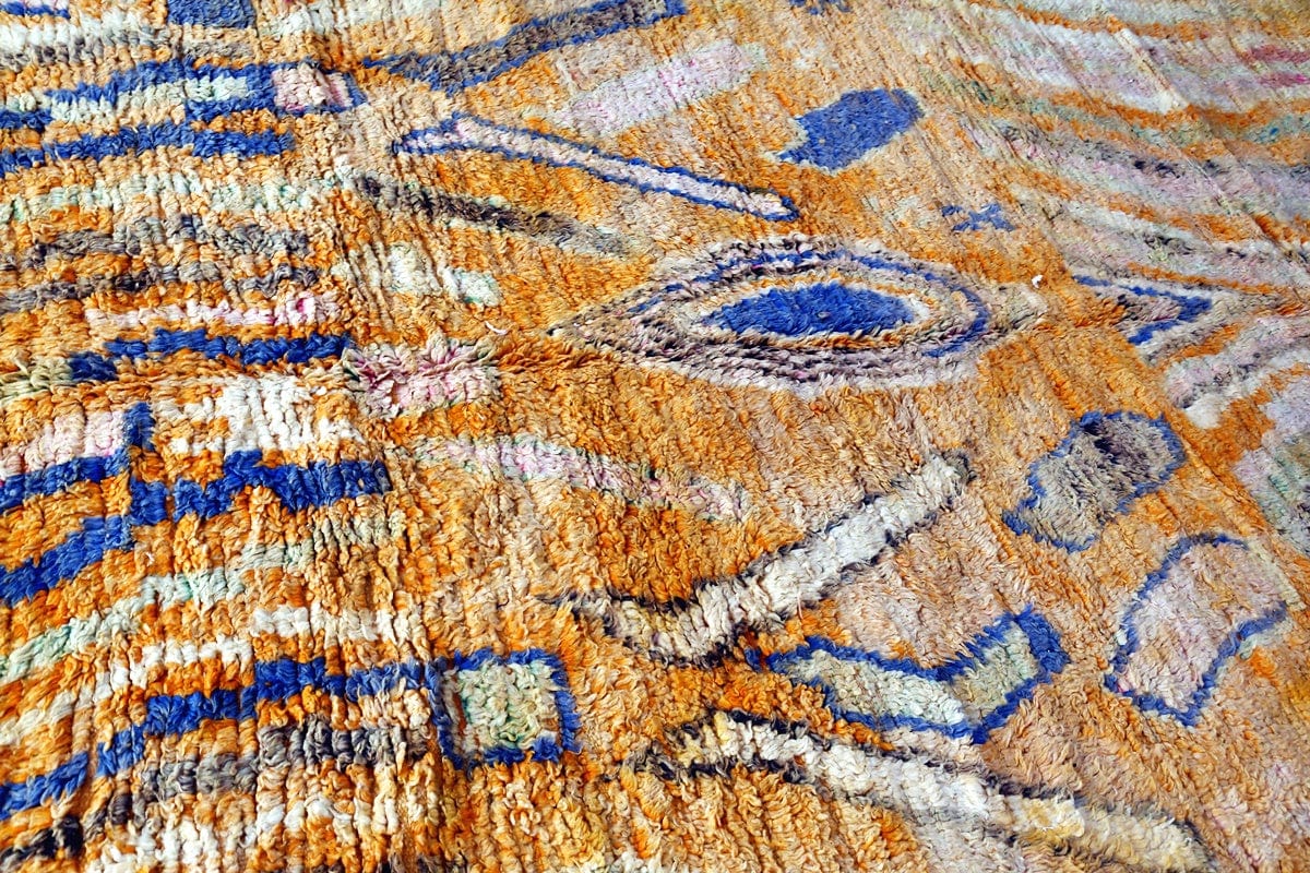 side shot orange boujaad moroccan rug with blue