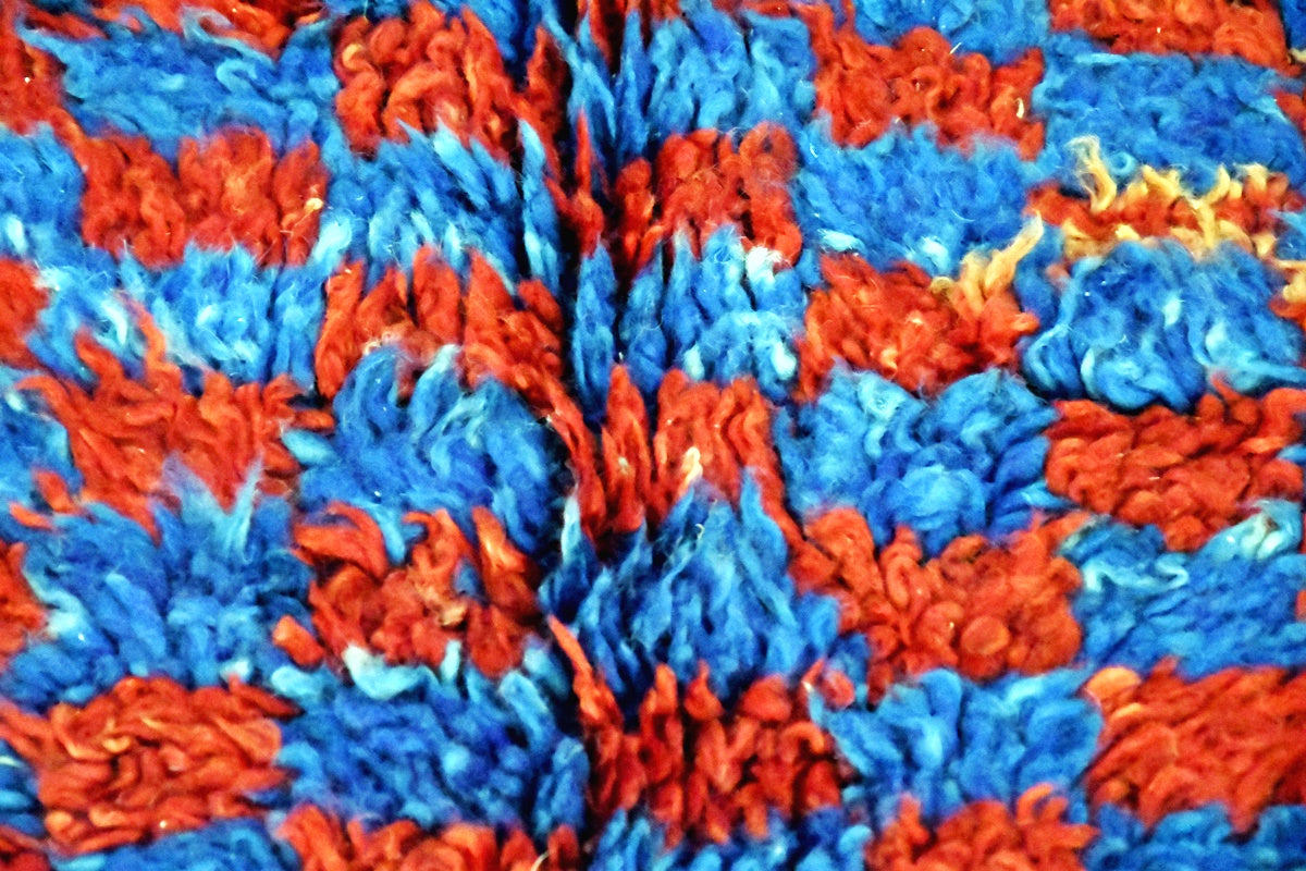 close up beni mguild checker rug blue indigo red