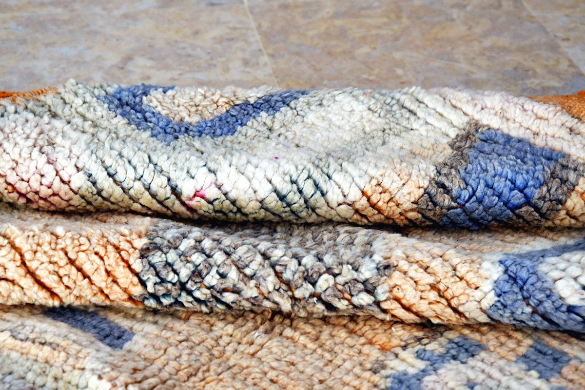 peach blue moroccan boujaad rug folded
