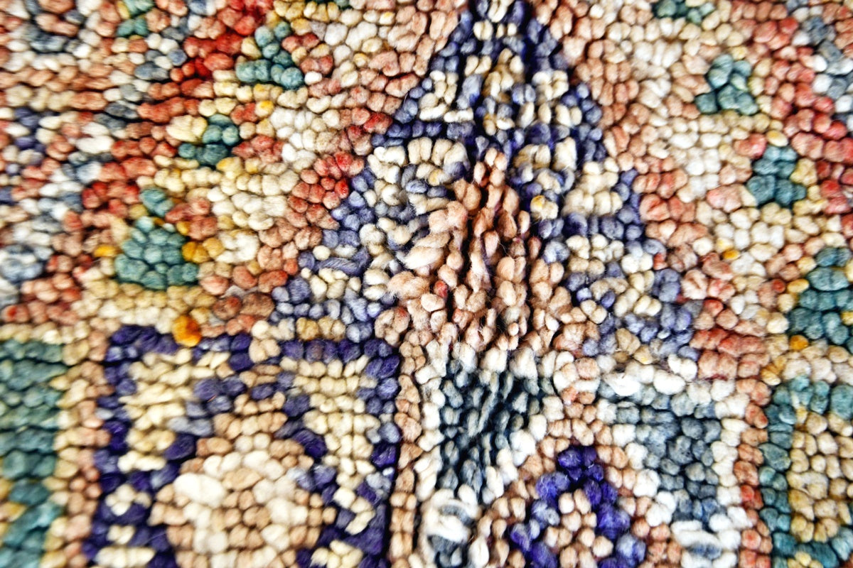 Close up faded rust green beni mguild rug