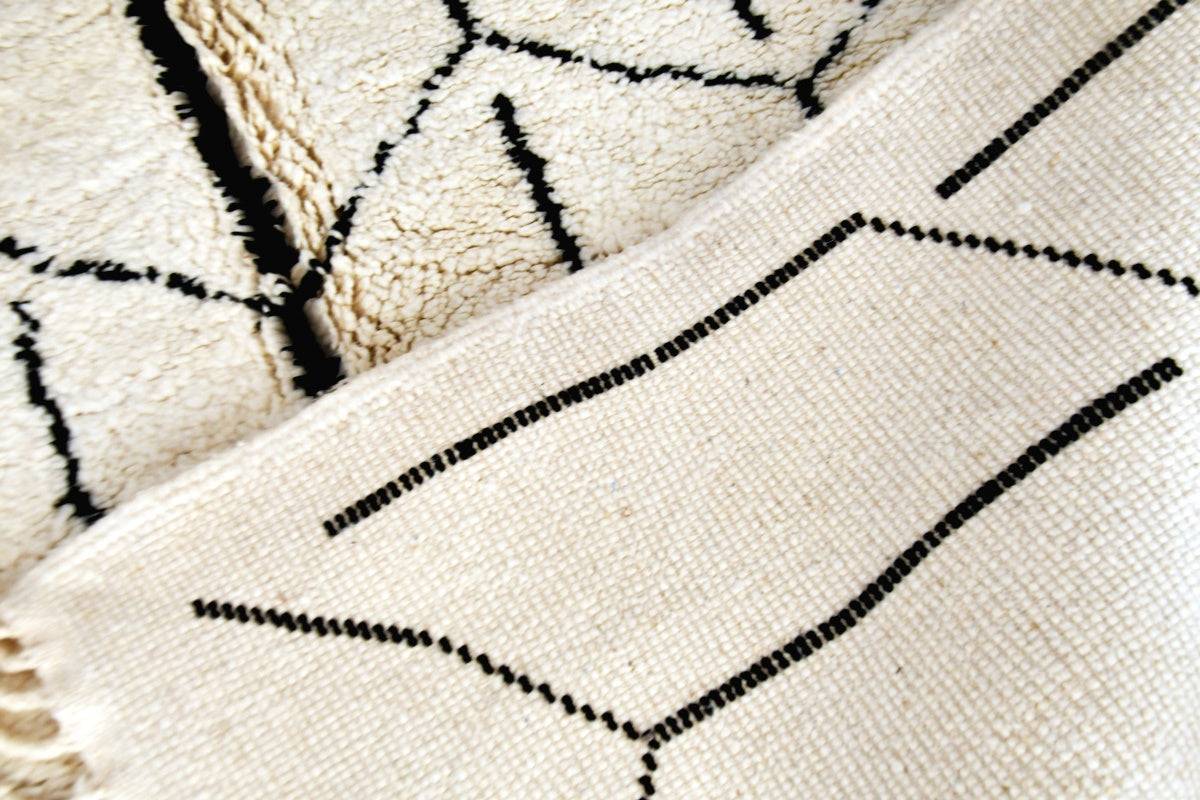 White black moroccan beni mrirt rug folded back