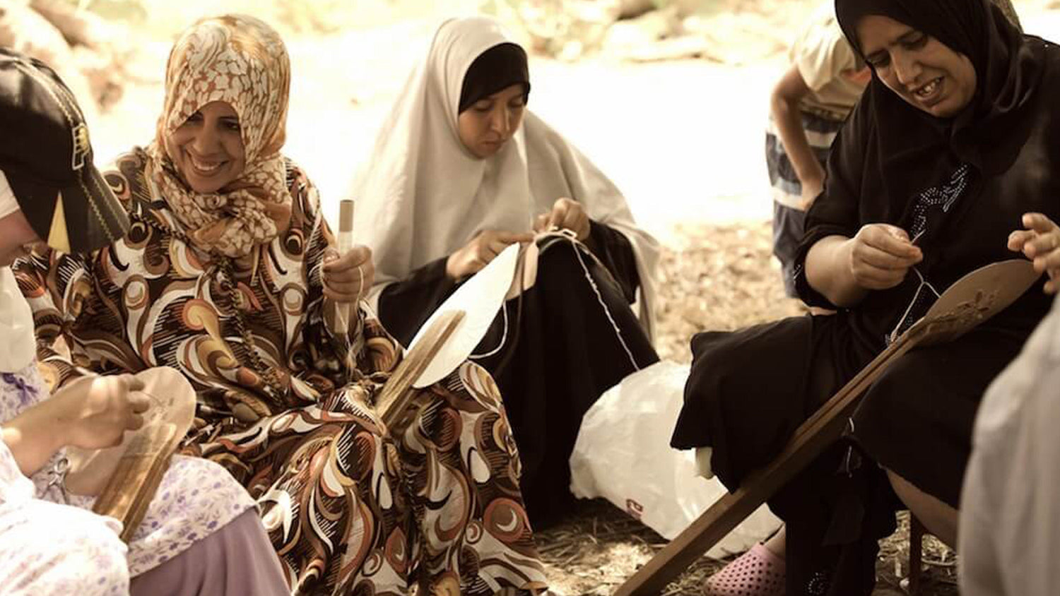Moroccan woman weaving rugs and spunning wool